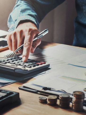 A person using calculator and counting