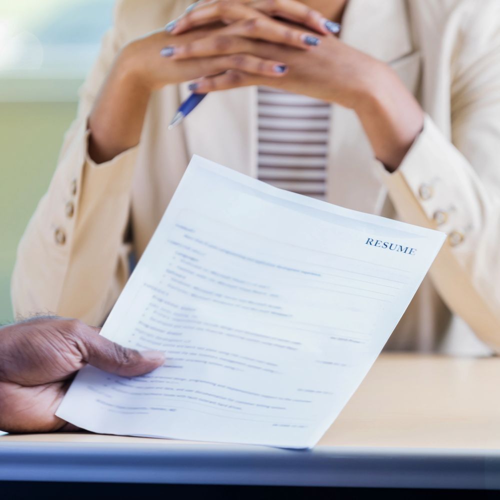 Person reviewing a resume during a job interview.