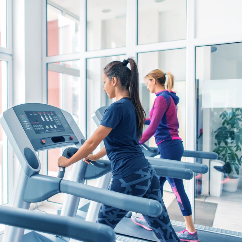Women running on treadmill in gym