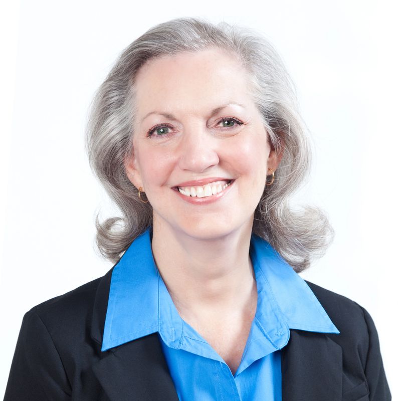 Portrait of smiling Caucasian senior woman against a white background.