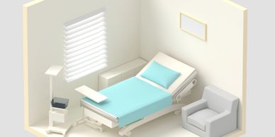 Minimalist hospital room with bed, armchair, and medical equipment.