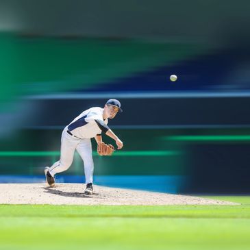 Baseball pitcher delivering a fastball on the mound.