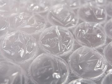 Close-up of bubble wrap with clear air-filled bubbles.