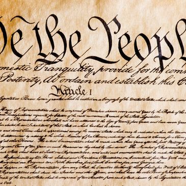Close-up of the US Constitution's opening words.