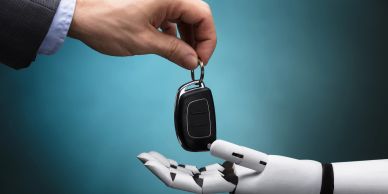 Robotic hand handing over car keys, symbolizing automated valet parking service