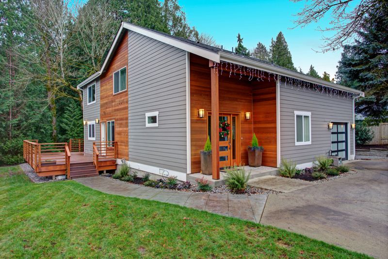 Charming newly renovated home exterior, natural wood siding and grey siding help to encrease curb appeal.