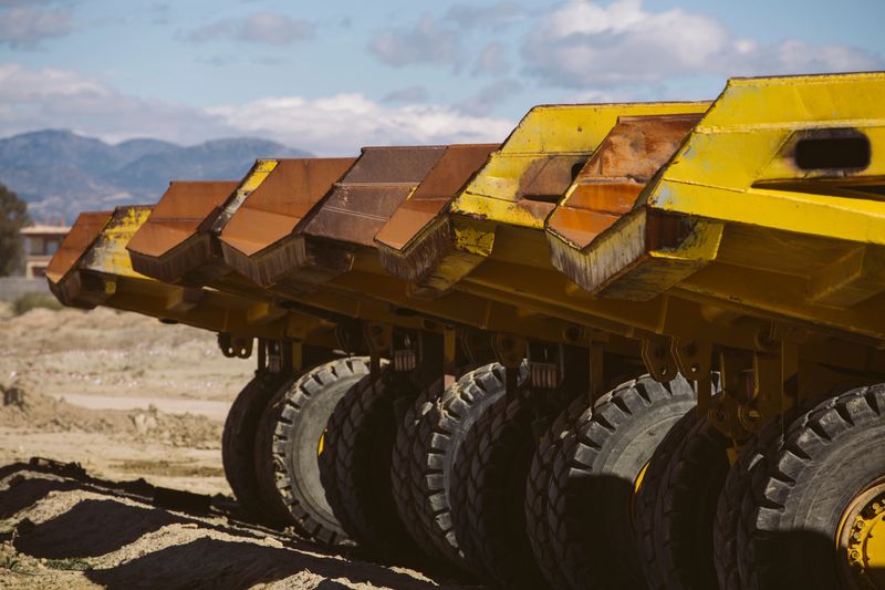 Dumper trucks parked on a construction site.