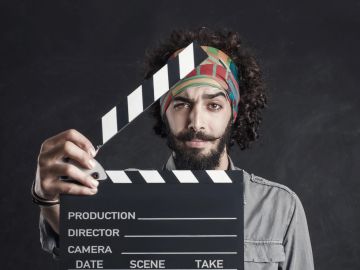 Man holding a film clapperboard.