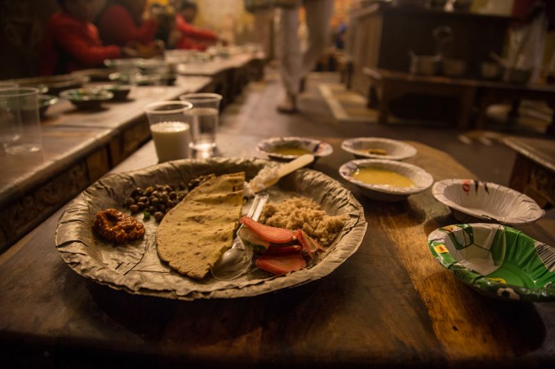 Vegetarian thali meals served on plates made from tree leaf, traditional Indian cuisine