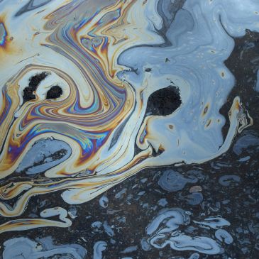 Colorful oil slick on water surface.