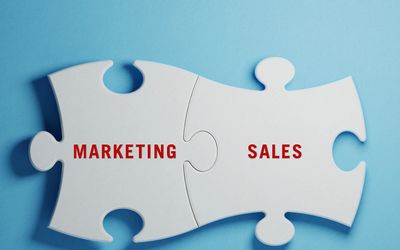 Marketing and sales puzzle pieces connected.