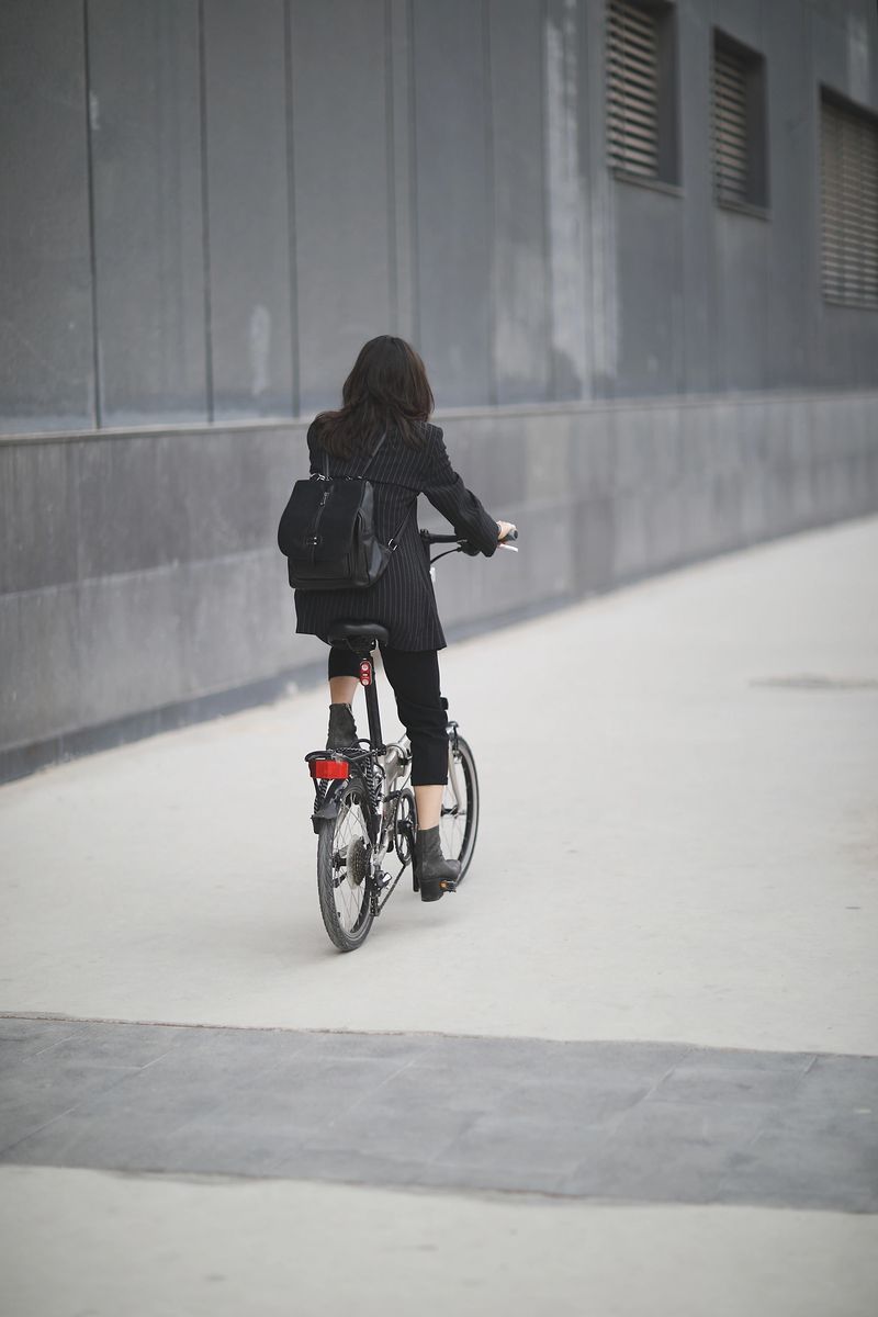 Businesswoman cycling in the city.