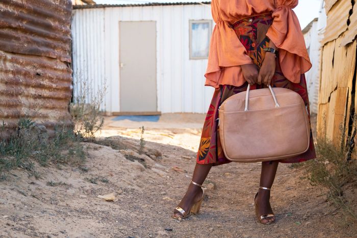 Elegant handbag store with modern shelves and soft lighting displaying various stylish bags.