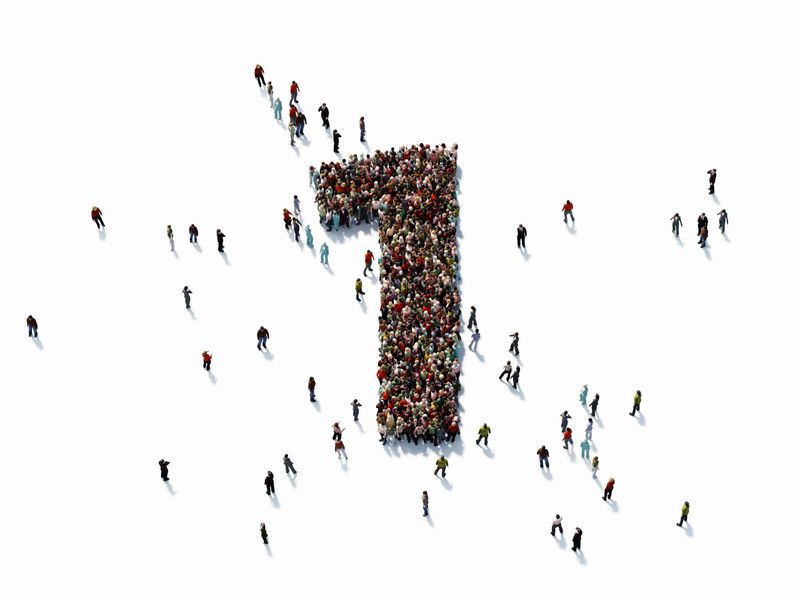 Human crowd forming a big number one on white background. Horizontal  composition with copy space. Clipping path is included. Success concept.