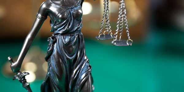 Statue of Lady Justice holding scales and sword.