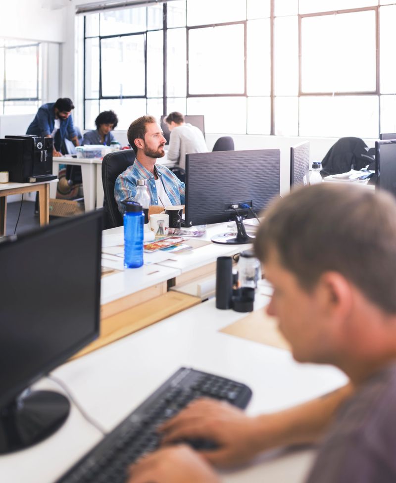 Business people working at desk. Professionals are using computers. They are at office.
