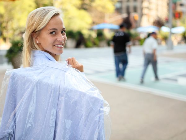 lady carrying dry cleaning