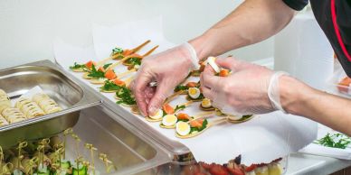 Preparing elegant finger foods and desserts for an event.