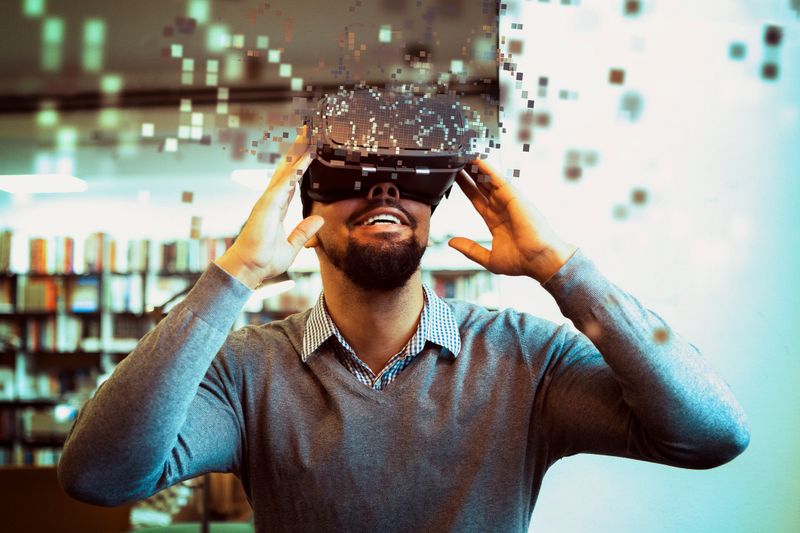 Young male student using Vr Headset for learning