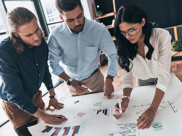 A group of people working on papers at a table.