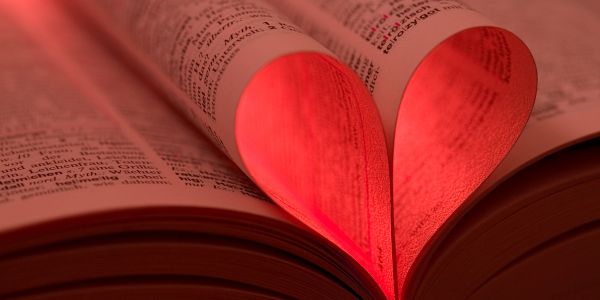 Book pages folded into a glowing red heart shape.