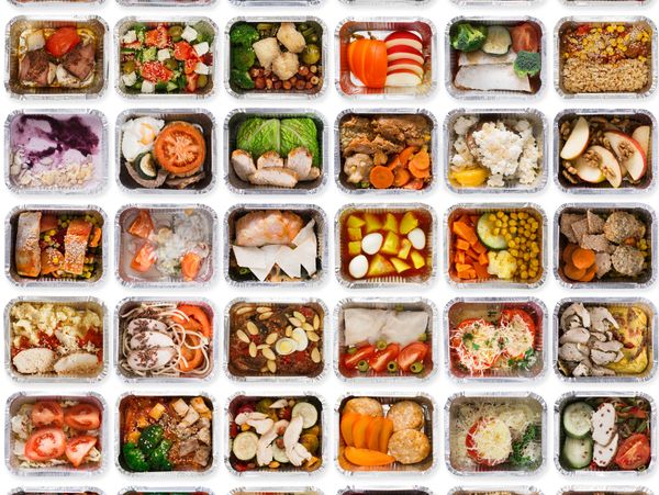 Array of assorted healthy meal prep containers with various foods.