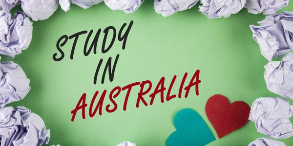 Creative text 'Study in Australia' on green background with heart shapes and crumpled paper border.
