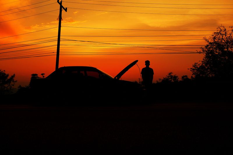 The car is breaking down on the road in the evening