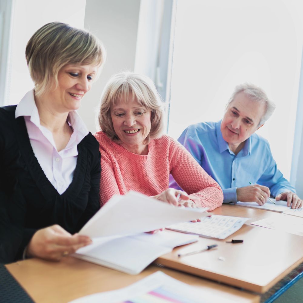 Couple viewing documents with an advisor