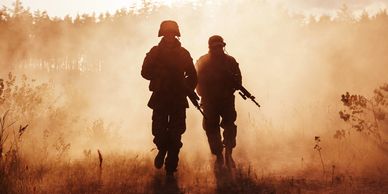 Two preppers walking with dust in the back ground  armed and ready