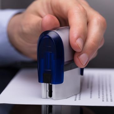 Man stamping a document to represent professional General Notary Public services in Kissimmee.