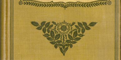 Antique book cover with floral and leaf design in dark green on a mustard yellow background.