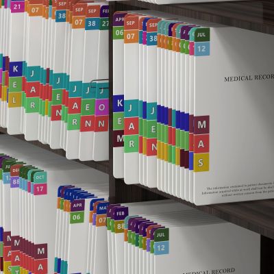 Stacked medical record folders with colorful labeled tabs.