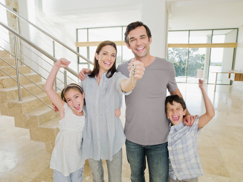 Family with keys celebrating new home