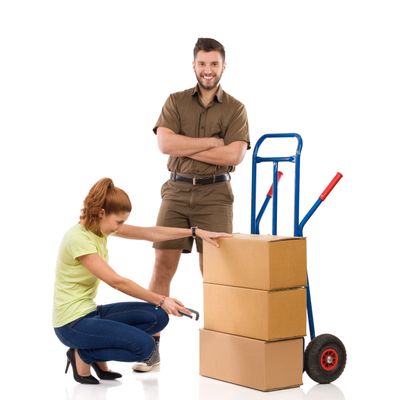 Woman scanning a package with a man standing beside a hand truck and boxes.