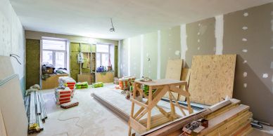 Room under renovation with construction materials and tools.