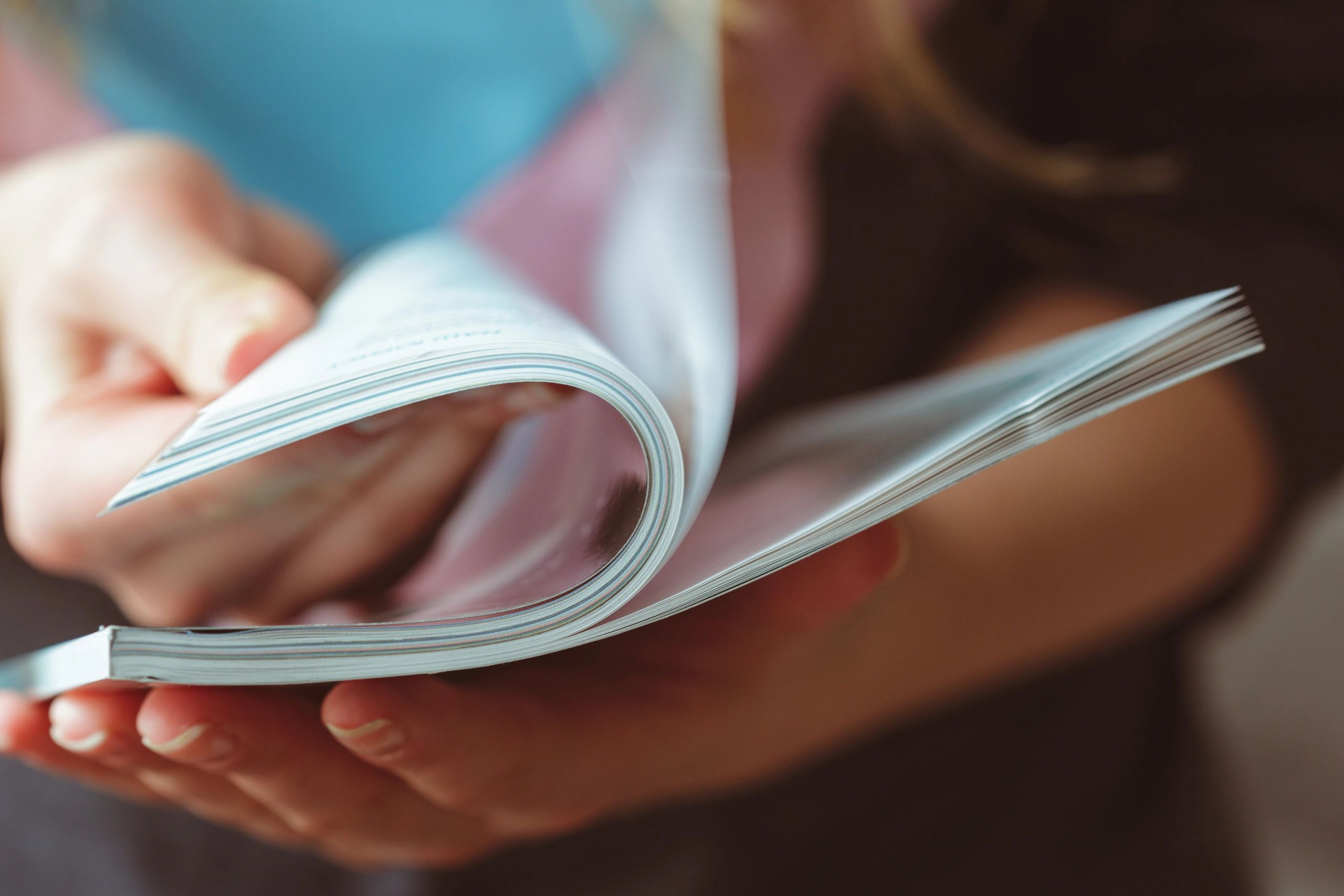 Close-up of flipping through a book or booklet.