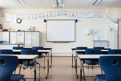 Empty classroom with chairs and a whiteboard.