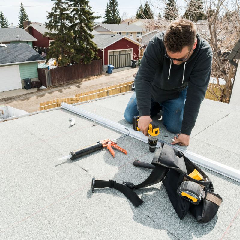 Workers installing racking and support for solar panels on a residential homes roof.