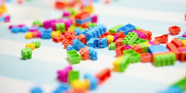 Colorful plastic building blocks scattered on a surface.