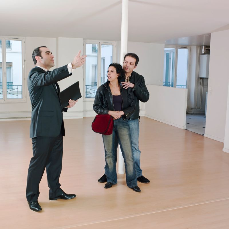 couple visiting apartment with Real Estate Agent