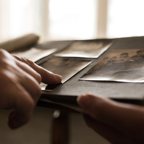 Hands going through old family photo album