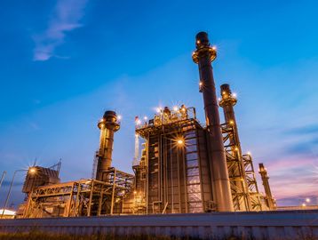 Power plant at dusk with vibrant sky.
