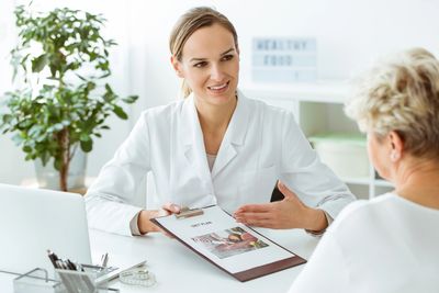Dietitian explaining a diet plan to a patient in a bright office.
