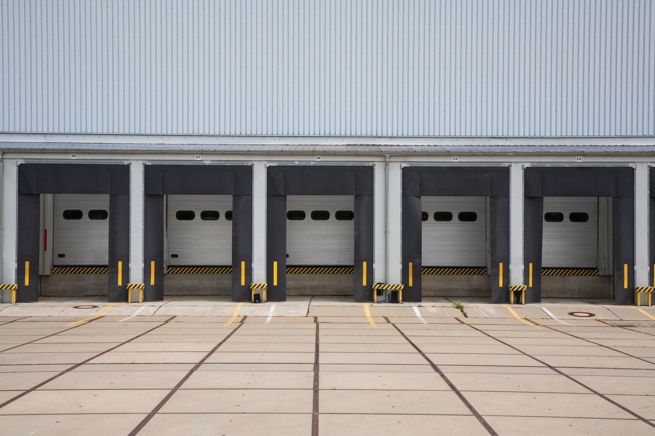 Five loading dock doors at a warehouse or distribution center.