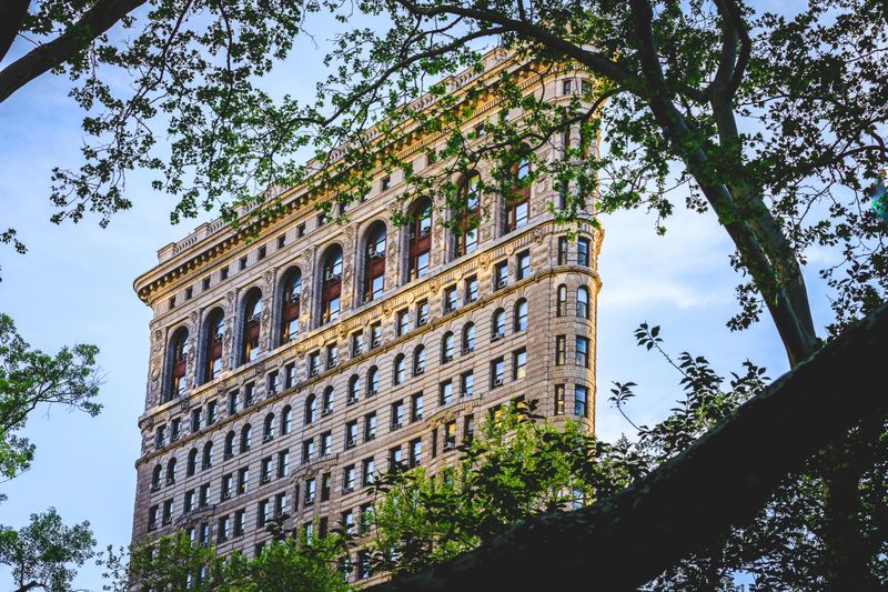 The Flatiron Building, as shot from Madison Square Park. Spring Trees in the foreground