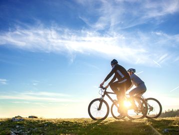 Two bicyclists at sunset