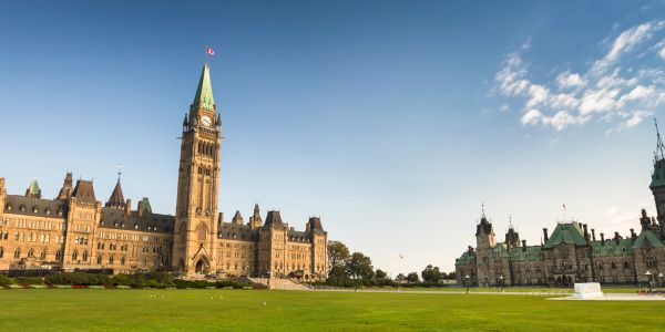 Canadian Parliament buildings under a clear sky.