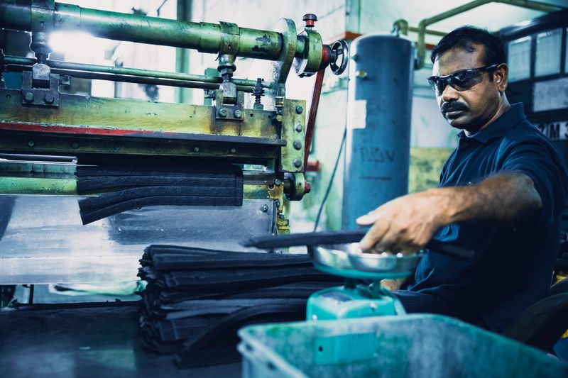 Factory worker weighing raw material before passing on to the next manufacturing process