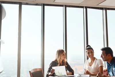 An entrepreneur reviewing financial documents at a desk.